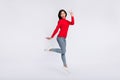 Full size photo of happy excited pretty woman jumping showing v-sign symbol isolated on grey color background Royalty Free Stock Photo