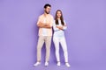 Full size photo of happy man and woman couple look each other folded arms good mood harmony isolated on purple color Royalty Free Stock Photo