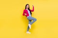 Full size photo of hooray brunette young lady hands fists wear pink sweater jeans on yellow background