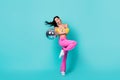 Full size photo of hooray millennial lady hold disco ball dance wear floral top pink pants isolated on turquoise color Royalty Free Stock Photo