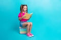 Full size photo of impressed girl dressed pink t-shirt skirt read interesting story in book isolated on turquoise color Royalty Free Stock Photo