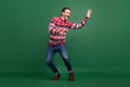 Full size photo of mature funky cool man look empty space dancer isolated on green color background