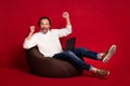 Full size photo of mature happy excited crazy businessman sit chair with laptop raise fists in victory isolated on red Royalty Free Stock Photo