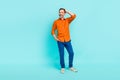 Full size photo of middle age businessman blue pants orange stylish shirt posing look curious mockup isolated over cyan