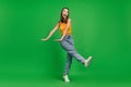 Full size photo of millennial funky brunette lady dance wear top jeans shoes isolated on green color background Royalty Free Stock Photo