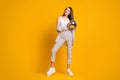 Full size photo of nice cute brown hair girl hold disco ball wear checked suit white tank-top shoes isolated over yellow Royalty Free Stock Photo