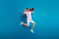 Full size photo of nice sporty person jumping carry boombox arm touch sunglass isolated on blue color background