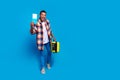 Full size photo of nice young man suitcase tickets empty space wear shirt isolated on blue color background Royalty Free Stock Photo