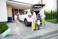 Full size photo of optimistic cute family pack baggage in car wear casual cloth near home outdoors Royalty Free Stock Photo