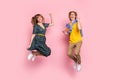 Full size photo of optimistic funny couple jump wear colorful clothes isolated on pastel pink background Royalty Free Stock Photo