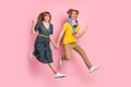 Full size photo of optimistic funny couple run wave hand wear colorful clothes isolated on pastel pink background Royalty Free Stock Photo
