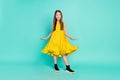 Full size photo of optimistic nice brown hair girl wear yellow dress shoes isolated on bright teal color background