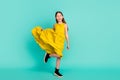 Full size photo of optimistic nice brown hair girl wear yellow dress shoes isolated on bright teal color background Royalty Free Stock Photo