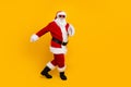 Full size photo of overjoyed elderly santa good mood dancing empty space new year occasion isolated on yellow color