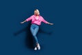 Full size photo of overjoyed funky pretty girl dressed pink shirt jeans pants dancing having fun isolated on dark blue Royalty Free Stock Photo
