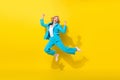 Full size photo of overjoyed good mood girl dressed blue jacket trousers jumping raising fists win gambling isolated on Royalty Free Stock Photo