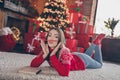 Full size photo of playful young lady sit on floor wear new year sweater jeans socks at home alone on christmas eve