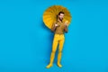 Full size photo of positive bearded student man use smartphone read social media news hold shine parasol shield wear