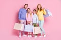 Full size photo of positive family daddy mommy small kids boy girl hold shopping bags isolated over pastel color Royalty Free Stock Photo