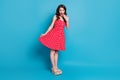 Full size photo of pretty lady mischief mood flirty raise skirt hand near mouth tricky wear summer red white dotted