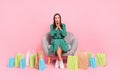 Full size photo of pretty young lady impressed choose shop sit longers isolated over pastel color background