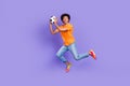 Full size photo professional guy coach soccer support fan jump energetic goalkeeper playing hold ball isolated on purple