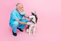 Full size photo of serious professional veterinarian wear blue uniform inspect listen husky stethoscope isolated on pink