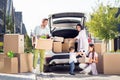 Full size photo of smiling happy family move pack stuff mom dad watch little boy give football ball to sister outside