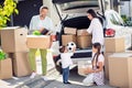 Full size photo of smiling happy family moving pack stuff dad mom and sister watch little boy put ball in automoble