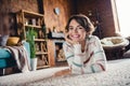 Full size photo of stunning satisfied glad girl laying floor toothy smile spend free time chilling flat inside Royalty Free Stock Photo