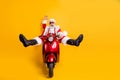 Full size photo of surprised crazy santa claus hipster in red hat shirt suspenders drive fast motorcycle hurry from