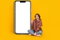 Full size photo of surprised girl direct finger phone display shocked unexpected new update apple ios isolated on yellow Royalty Free Stock Photo