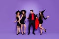 Full size photo of three witch ladies and warlock guy chilling at halloween event crazy dancing wear black dresses hats Royalty Free Stock Photo