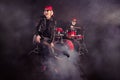 Full size photo of two cool aged lady man rock group performing concert drum instruments play solo guitar fog in air Royalty Free Stock Photo