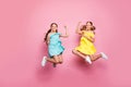Full size photo of two friendship small sisters ladies jumping high celebrate summer holidays last school day wear blue Royalty Free Stock Photo