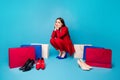 Full size photo of upset sorrow lady successful worker sitting offended near shoes shopping bags wear red suit blouse Royalty Free Stock Photo