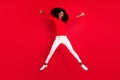 Full size photo of young african woman happy positive smile have fun jump up funky isolated over red color background Royalty Free Stock Photo