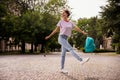 Full size photo of young afro woman happy positive smile have fun hold rucksack go walk nature outdoors