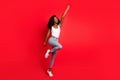 Full size photo of young attractive black girl happy positive smile look empty spae superhero isolated over red color Royalty Free Stock Photo