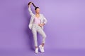 Full size photo of young attractive lovely happy funky funny businesswoman pull ponytail isolated on violet color