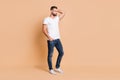 Full size photo of young attractive serious confident man look empty space hand in pocket isolated over beige color Royalty Free Stock Photo