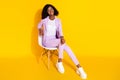 Full size photo of young beautiful charming cute afro businesswoman sit char relaxing isolated on yellow color Royalty Free Stock Photo