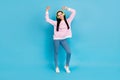 Full size photo of young cheerful woman have fun dance hang-out listen music headphones isolated over blue color Royalty Free Stock Photo