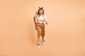 Full size photo of young crazy girl go walk run speed jump up sale isolated over beige color background