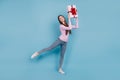 Full size photo of young cute nice attractive confident girl holding big gift box in hands isolated on blue color Royalty Free Stock Photo