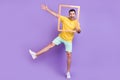 Full size photo of young excited man happy positive smile fooling snapshot frame isolated over violet color background