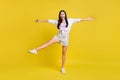 Full size photo of young funky funny excited smiling careless girl fooling around isolated on yellow color background