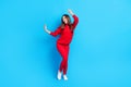 Full size photo of young girl happy positive smile have fun enjoy music dance isolated over blue color background Royalty Free Stock Photo