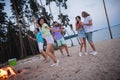 Full size photo of young guys ladies drink beer dance wear casual outfil by the sea