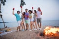 Full size photo of young guys ladies drink beer wear casual outfil by the sea